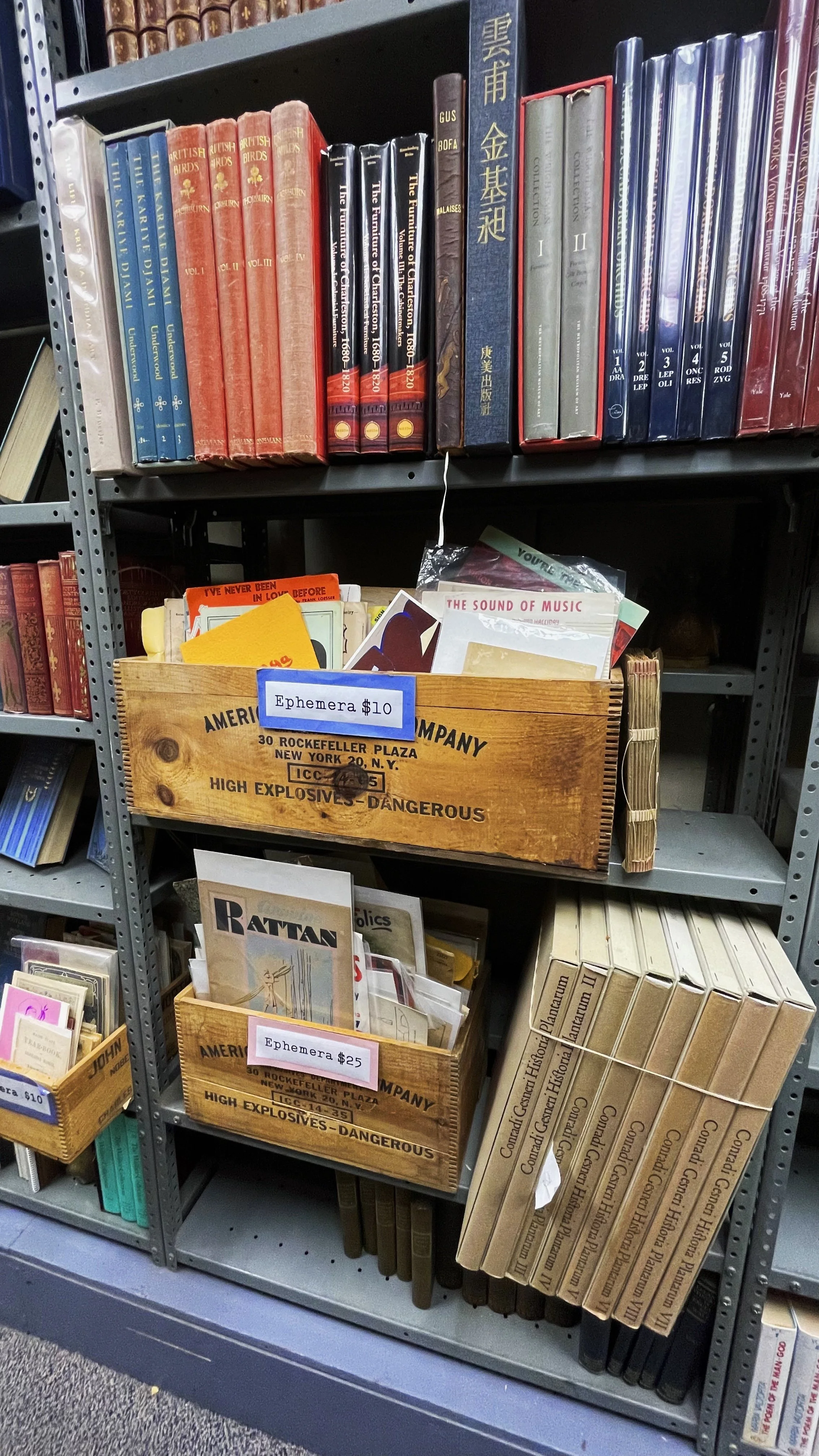 Mementos, pamphlets, and more, on display in antique crates, once used to hold explosives in NYC.
