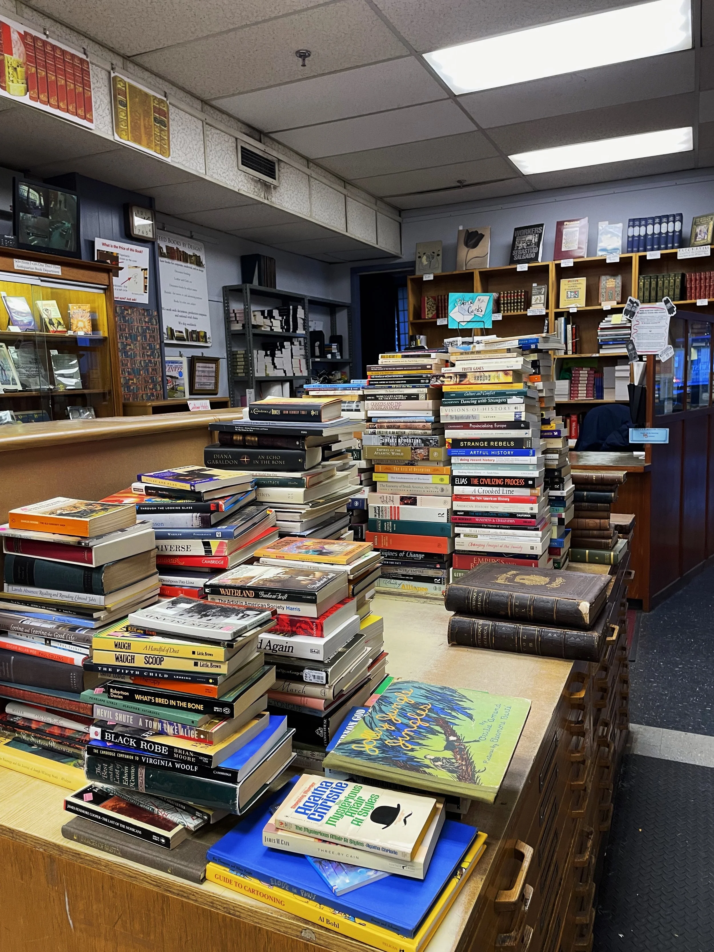 Piles of books waited to be shelved towards the front of the store.