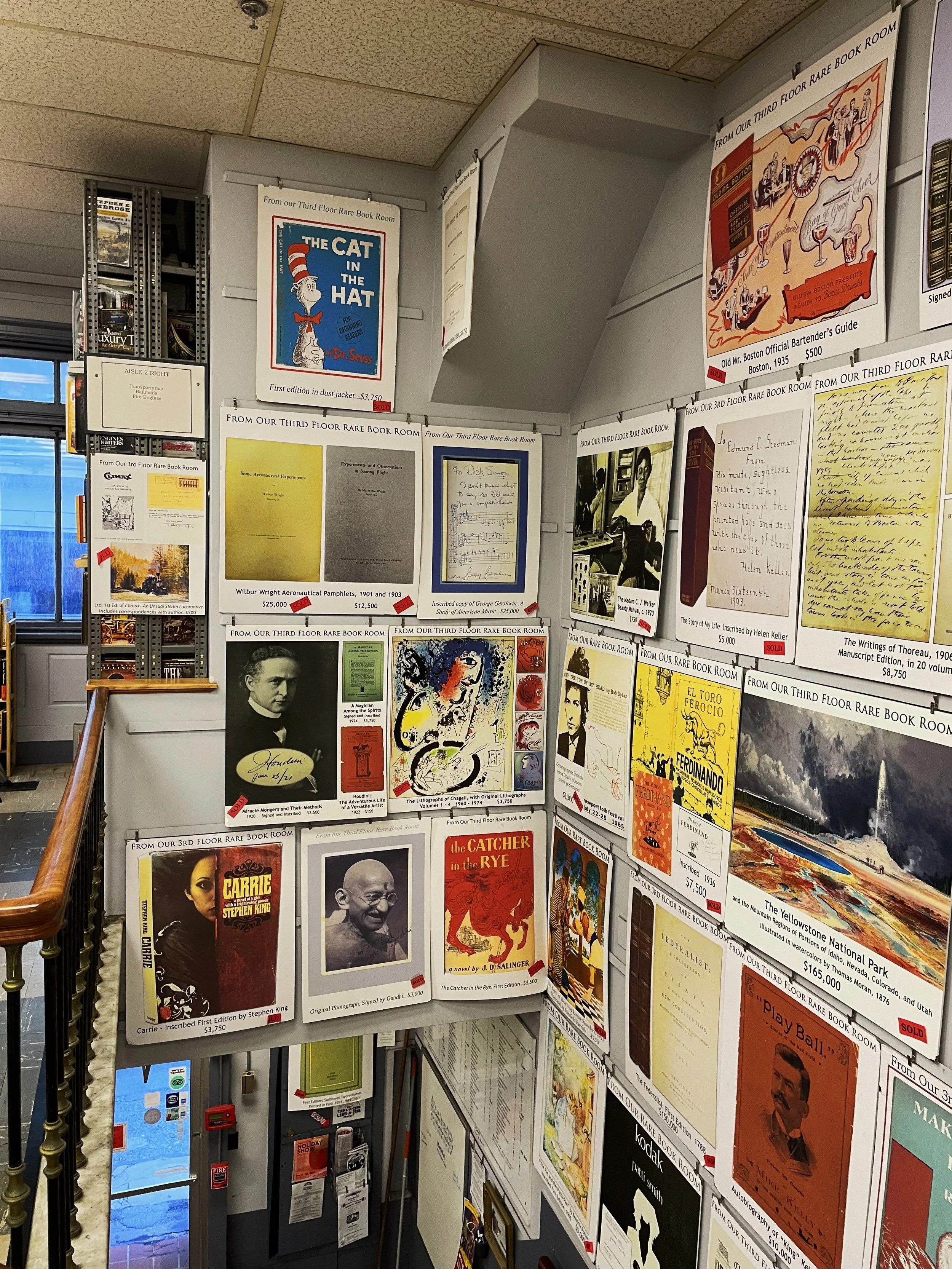 Vintage prints from the third floor book room, on display above the staircase leading to the second floor.