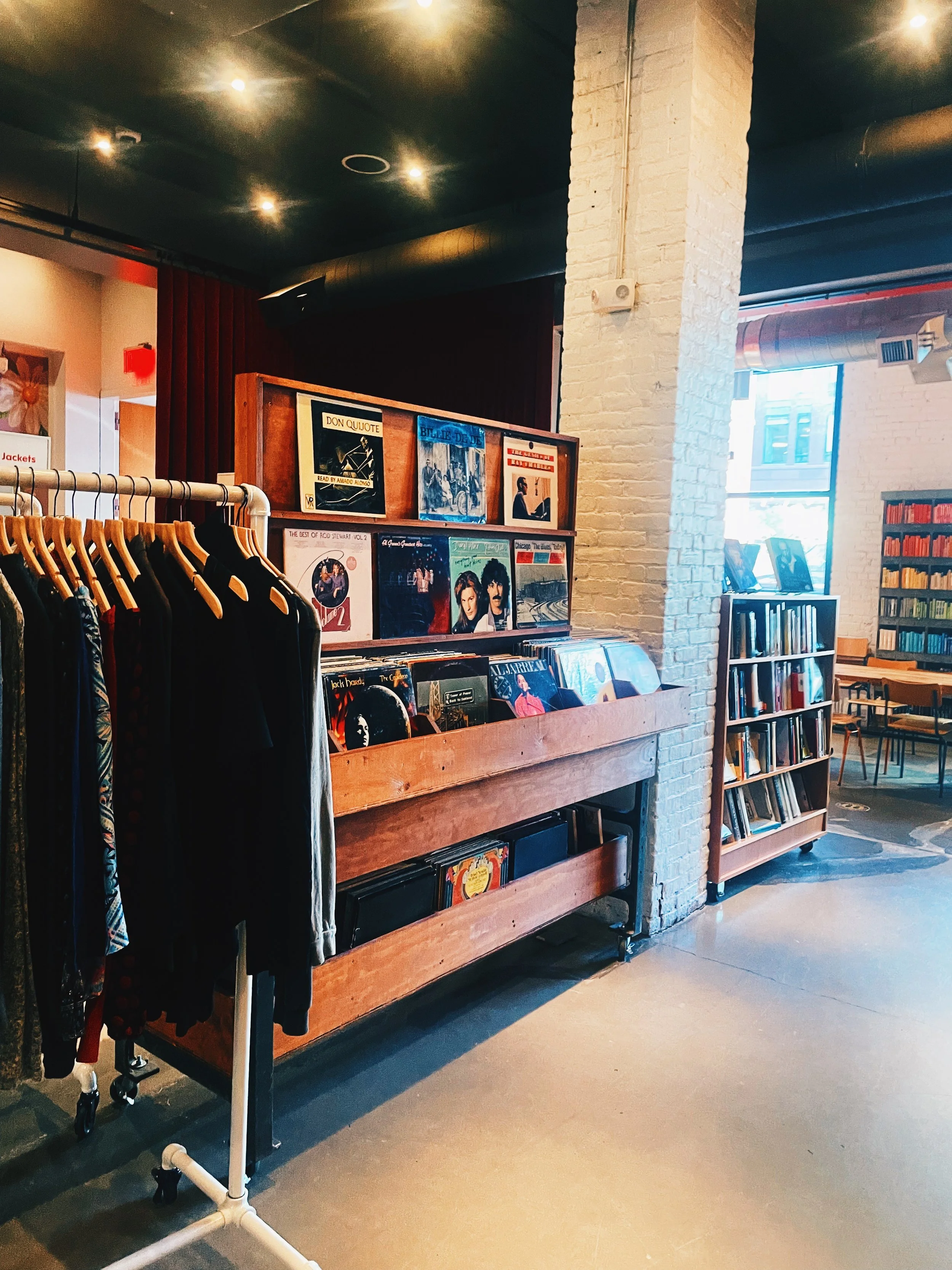 A vast variety of vinyl records are displayed for sale towards the back of the store.